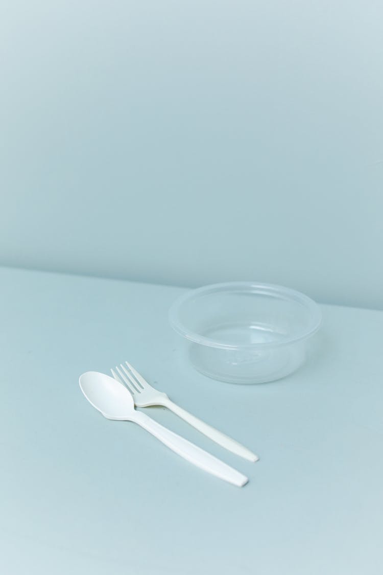 White Plastic Spoon And Fork Beside Clear Glass Bowl