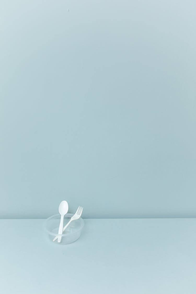 Plastic Spoon And A Fork In A Bowl