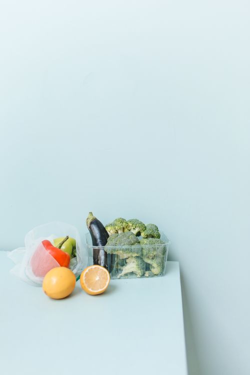 Free A collection of fresh vegetables and fruits on a light blue background. Stock Photo