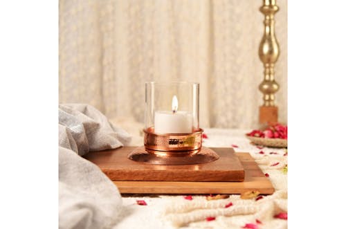 Close-Up Shot of a Lighted Candle on a Wooden Tray