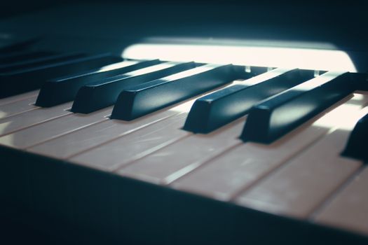 Detailed close-up of piano keys with dramatic lighting in Málaga, Spain.