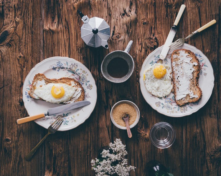 Breakfast Meals Beside A Cup Of Coffee On A Wooden Table