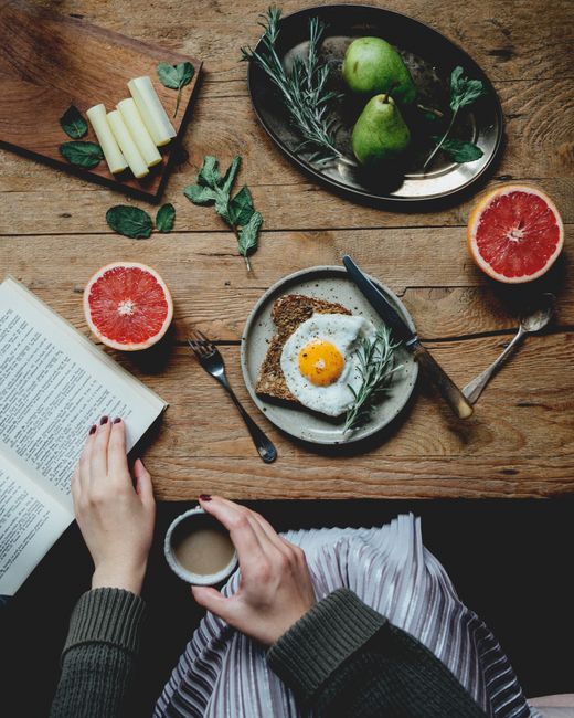 Cozy breakfast with toast, grapefruit, and coffee in a rustic setting.