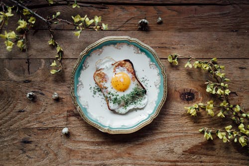 Free Close-Up of a Toasted Bread with Egg on a Plate Stock Photo