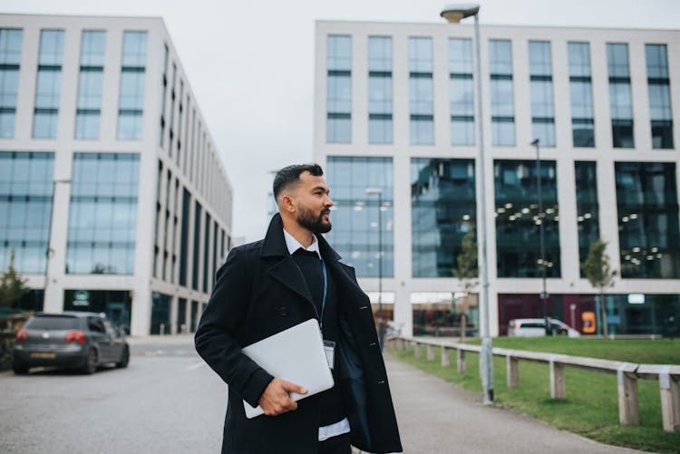 Trendy Ethnic Office Employee With Laptop On Urban Road