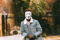 Unrecognizable black man in mask of anonymous in city