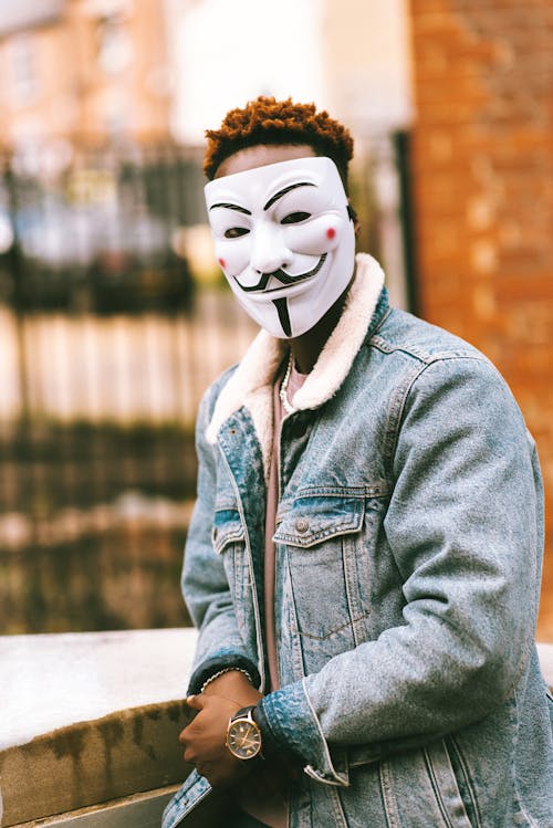 Free Man in Denim Jacket Wearing a Creepy Mask Stock Photo