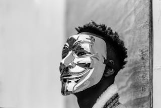 Black activist wearing Anonymous mask as sign of protest