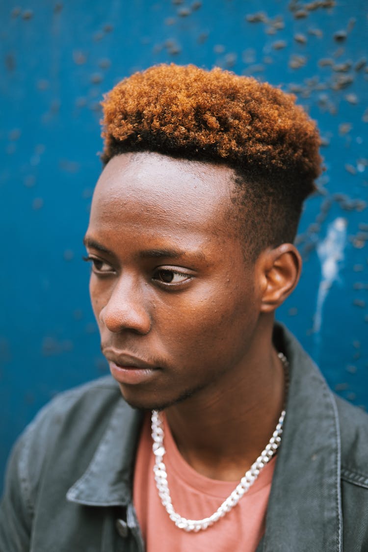 Calm Black Man In Casual Wear Against Blue Wall