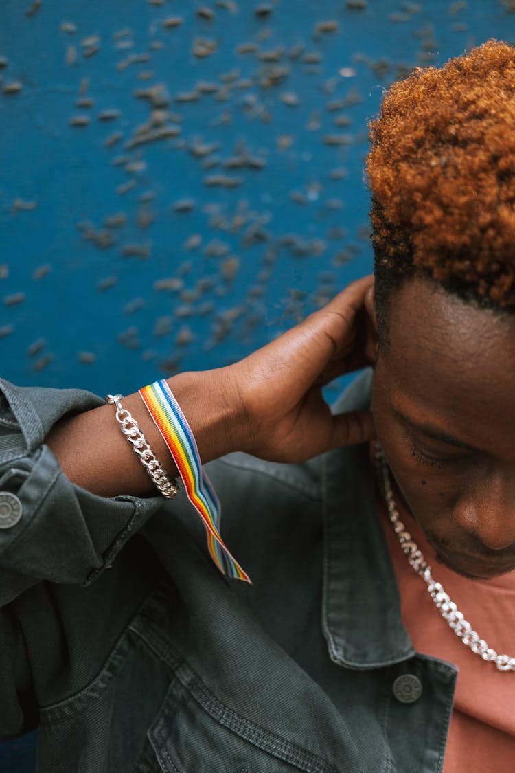 Crop Pensive Black Man Wearing Rainbow Bracelet And Touching Neck