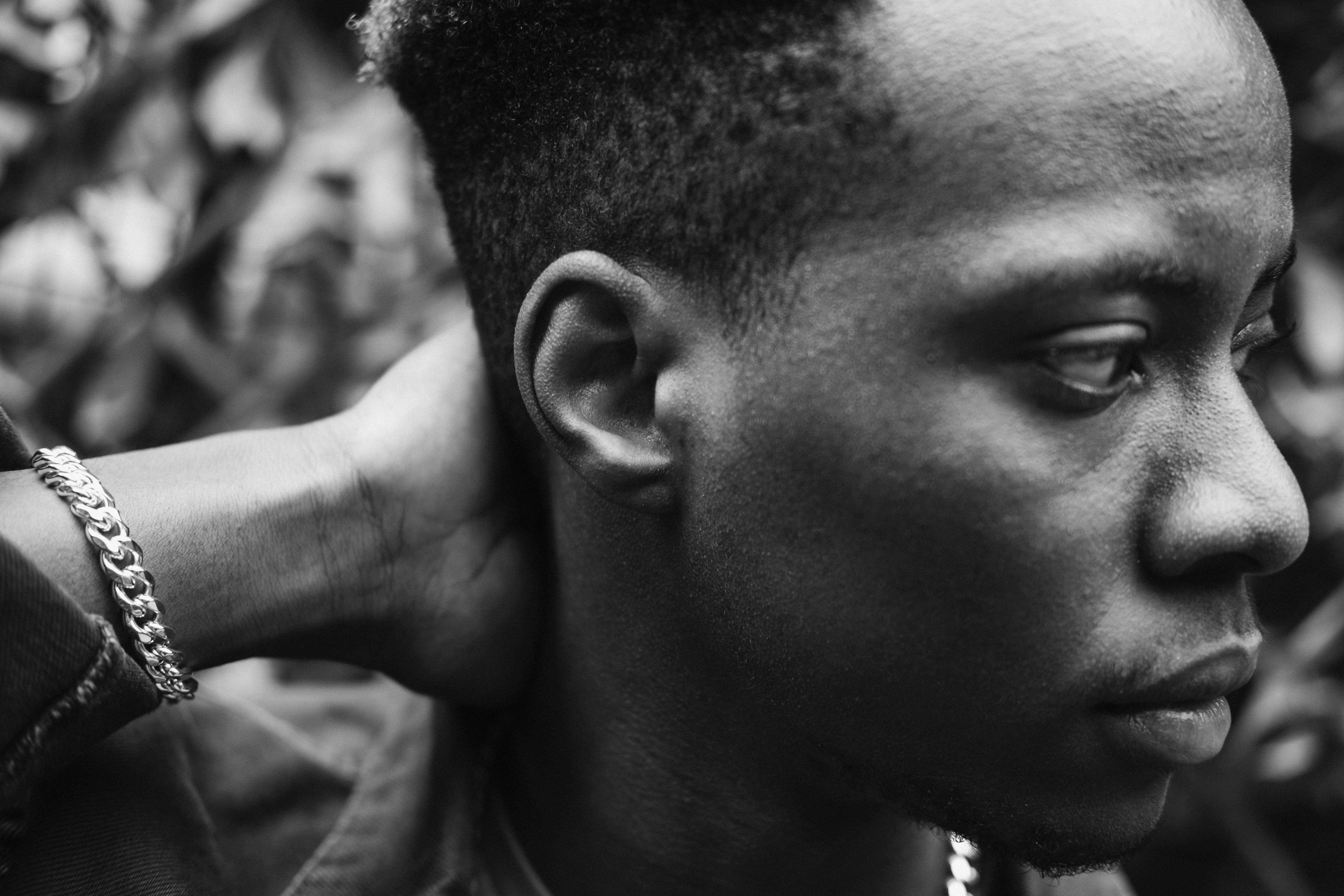 Black man with feather in hand · Free Stock Photo