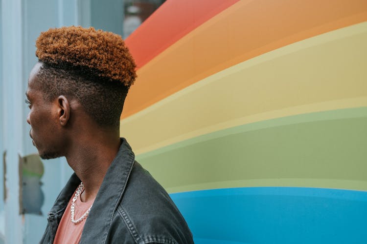 Stylish African American Man Near Graffiti Wall With Pride Flag