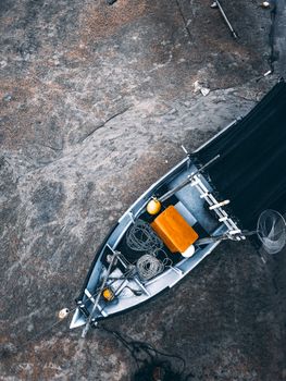 Fishing boat on rocky rough coast