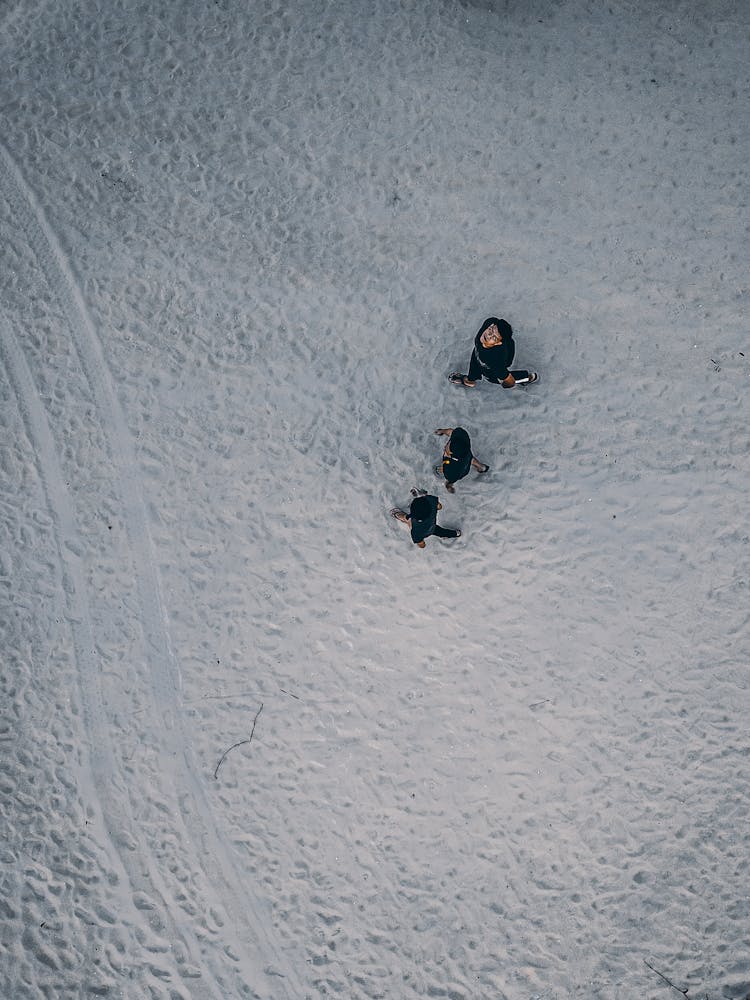 People Walking On Endless White Sand