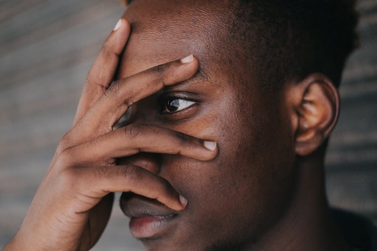 Crop Black Man Touching Face With Hand