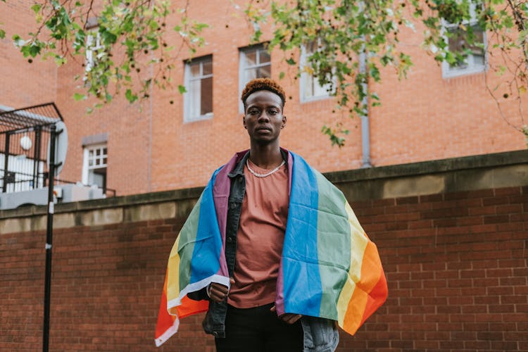 Black Man With Rainbow Flag On Street