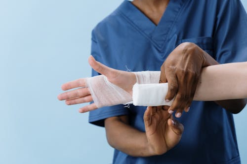 Free A Person Getting his Hand Bandaged Stock Photo
