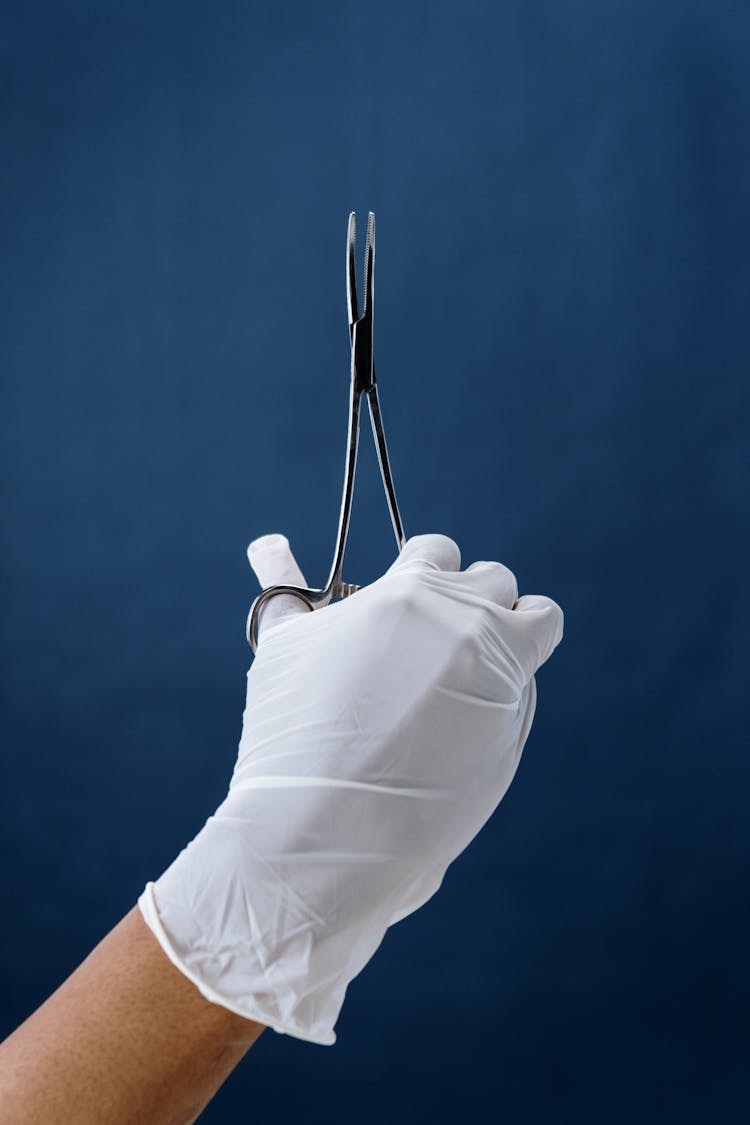 Close-Up Shot Of A Person Holding Forceps