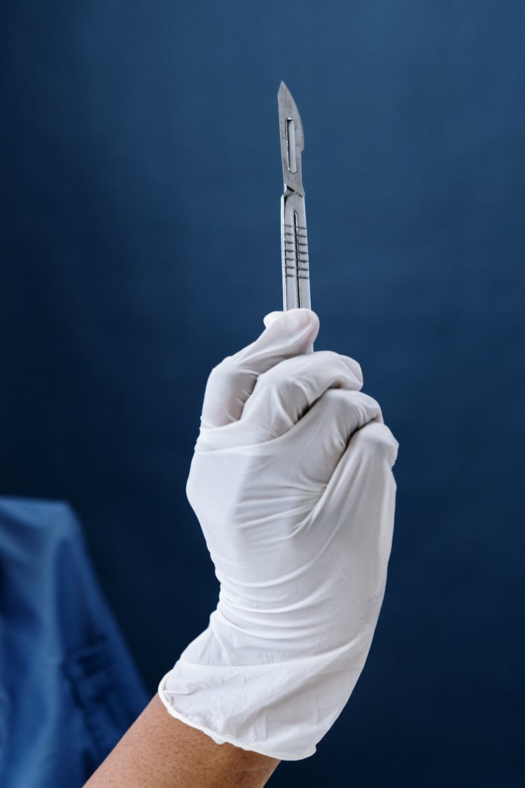 Close-Up Shot Of A Person Holding A Scalpel