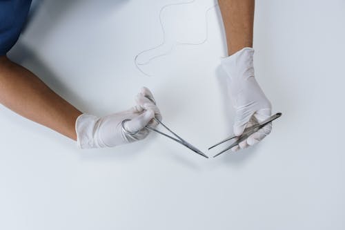 Top View of a Healthcare Professional Holding Surgical Equipment