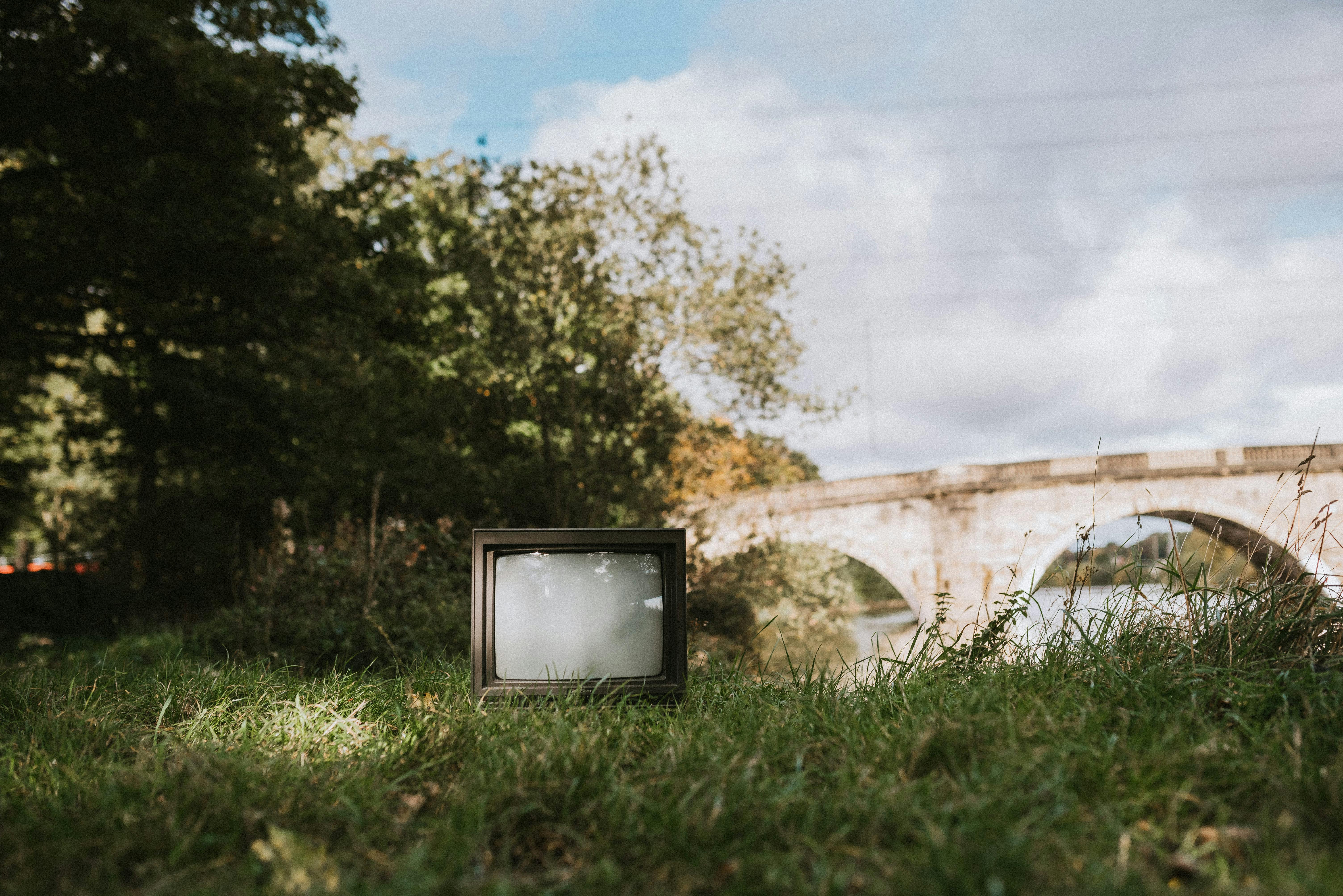 old tv set on grassy coast