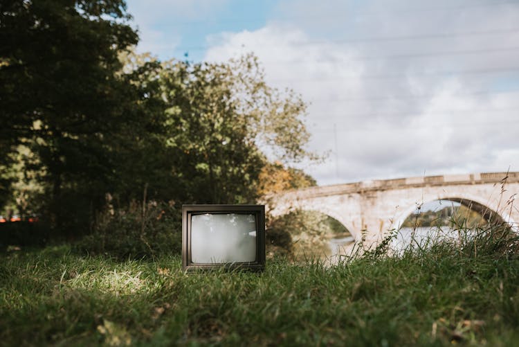 Old TV Set On Grassy Coast