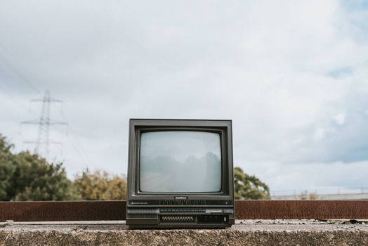 Retro TV set placed on stone surface