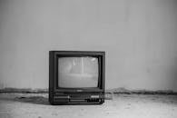 Vintage TV set on floor near wall