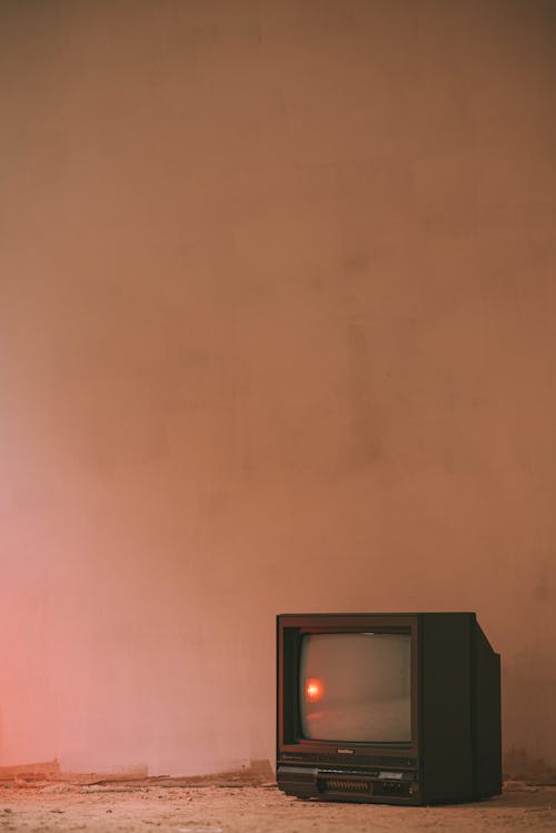 Free Aged TV set on concrete floor in building Stock Photo