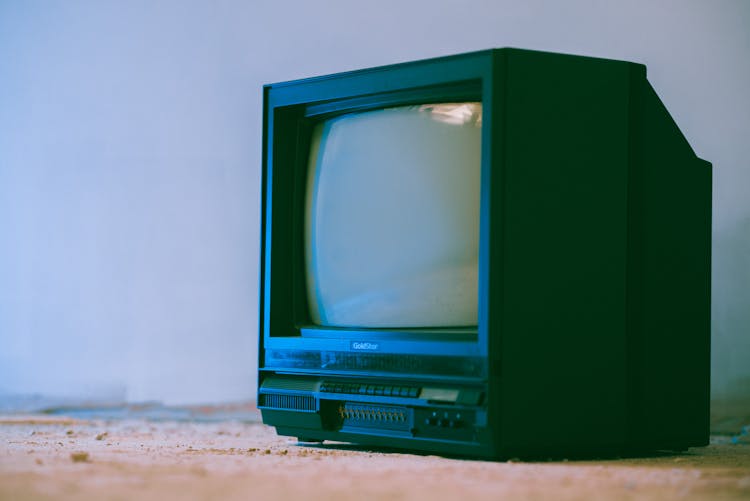 Old Telly On Rough Floor In House