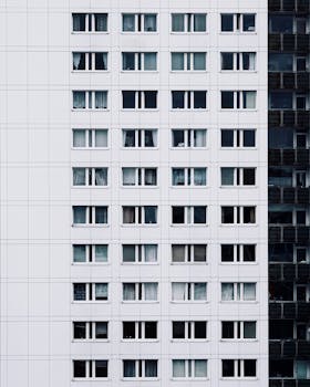 Vertical shot of a contemporary apartment building facade with windows in Berlin, Germany.