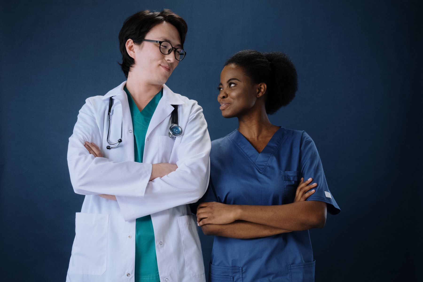 Doctor and nurse standing together as a coordinated multi-location care team