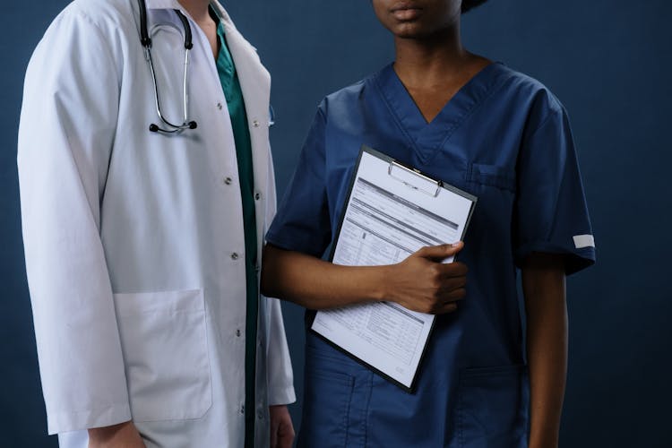 Doctors In Scrubs On Blue Background