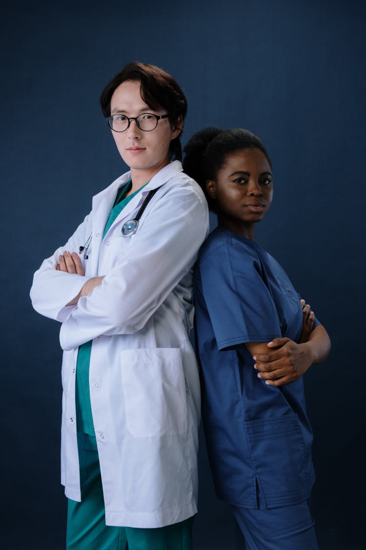 A Nurse And A Doctor Standing Back To Back 