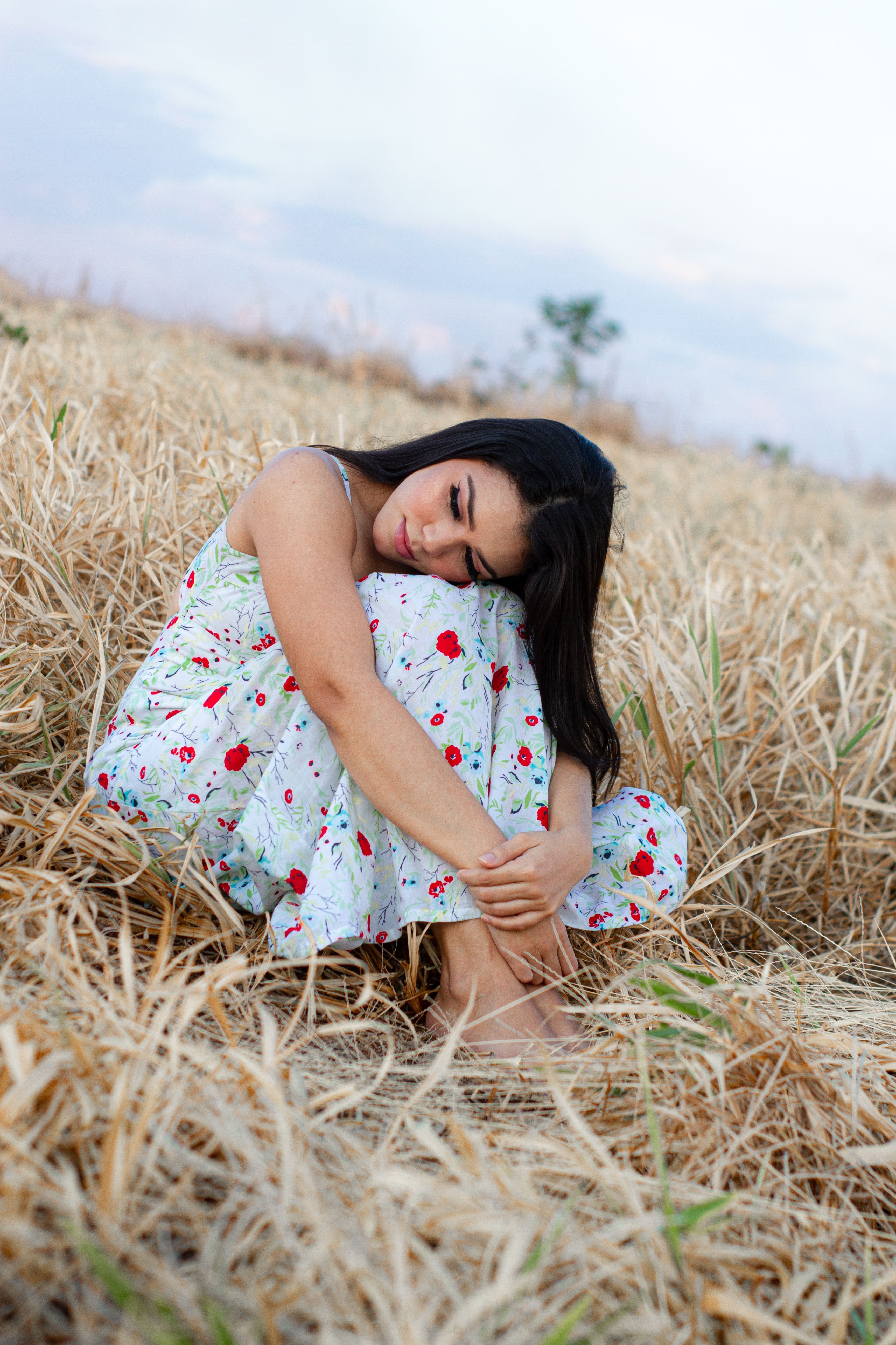 Woman in Pink Dress Sitting on Grass Field · Free Stock Photo