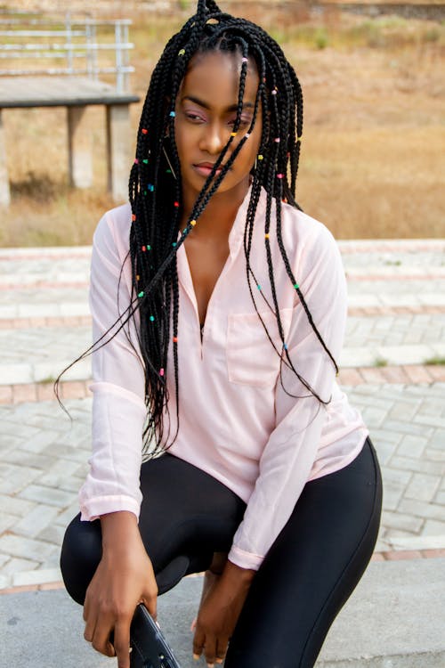 Dreamy black woman with Afro braids