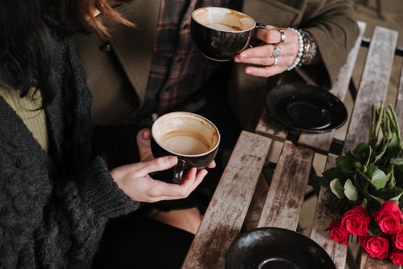 People holding coffee cups in a café