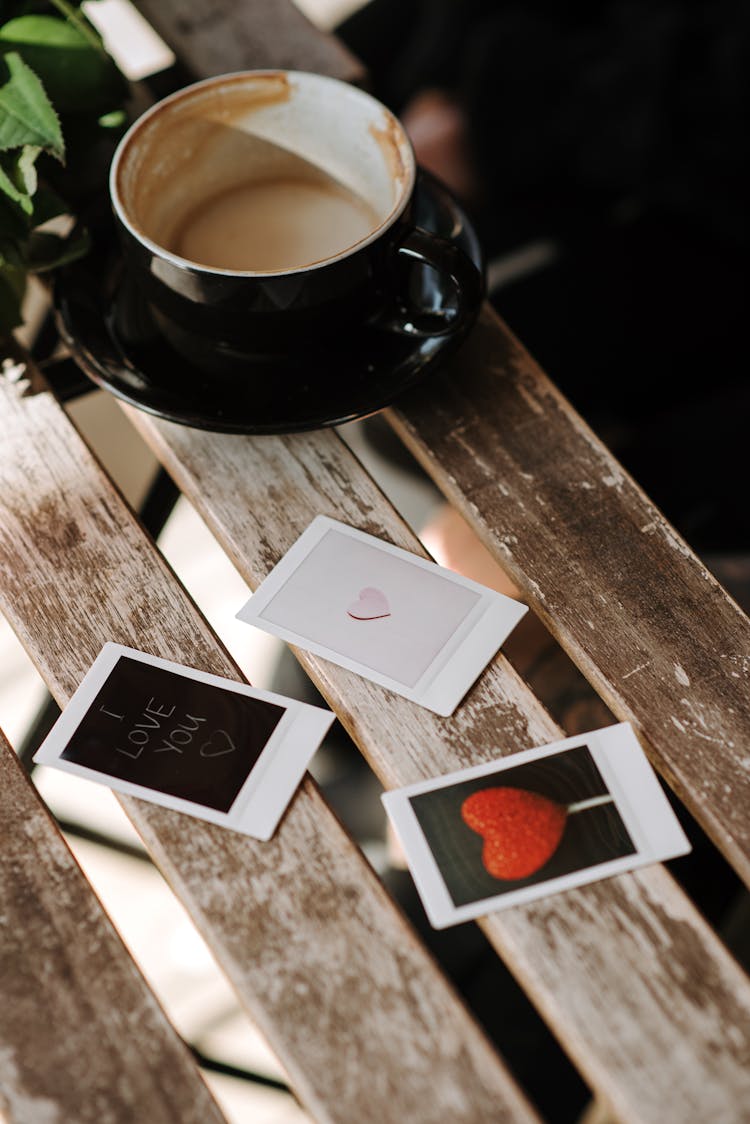 Assorted Instant Photos With Heart Symbols Near Cup Of Cappuccino