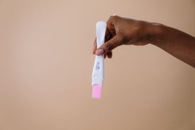 Woman researching at-home insemination methods on her phone