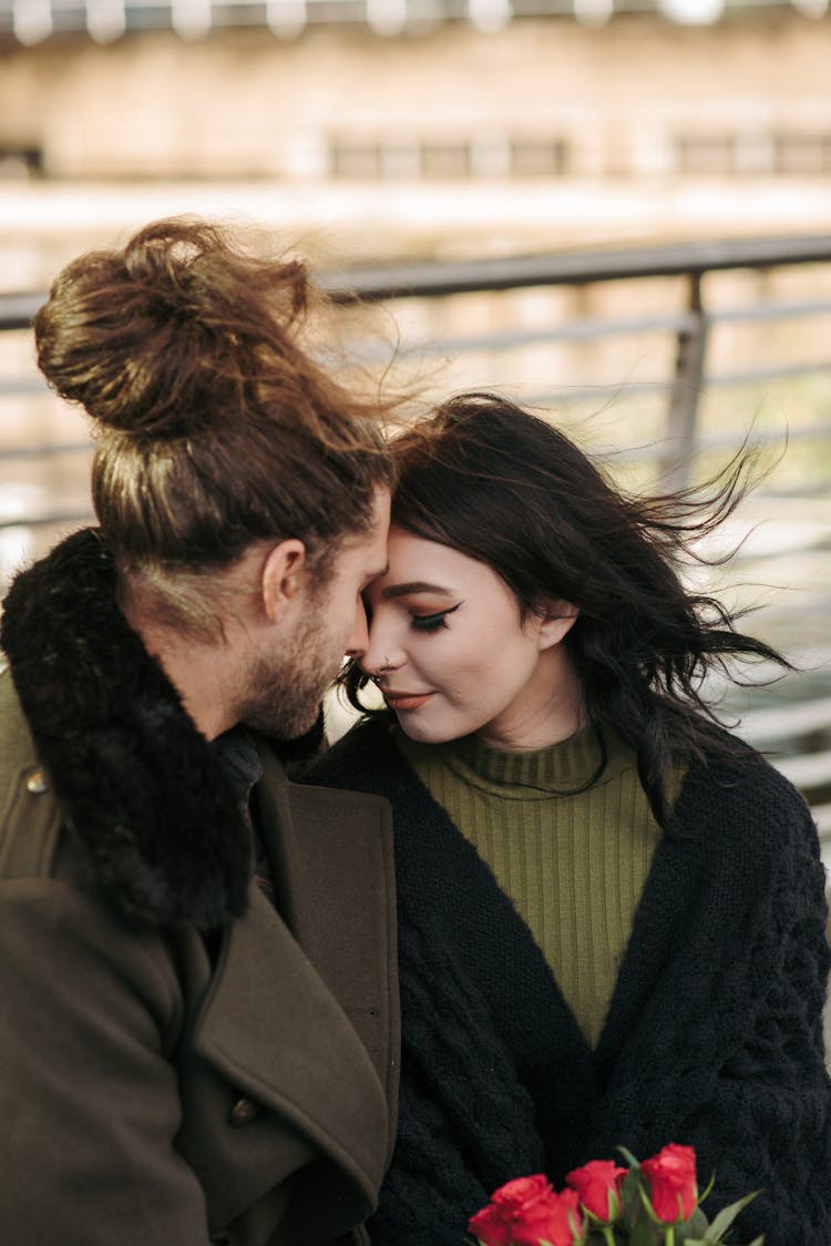 Tender Young Couple Touching Foreheads On Street