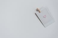 Instant photo with small heart on white surface