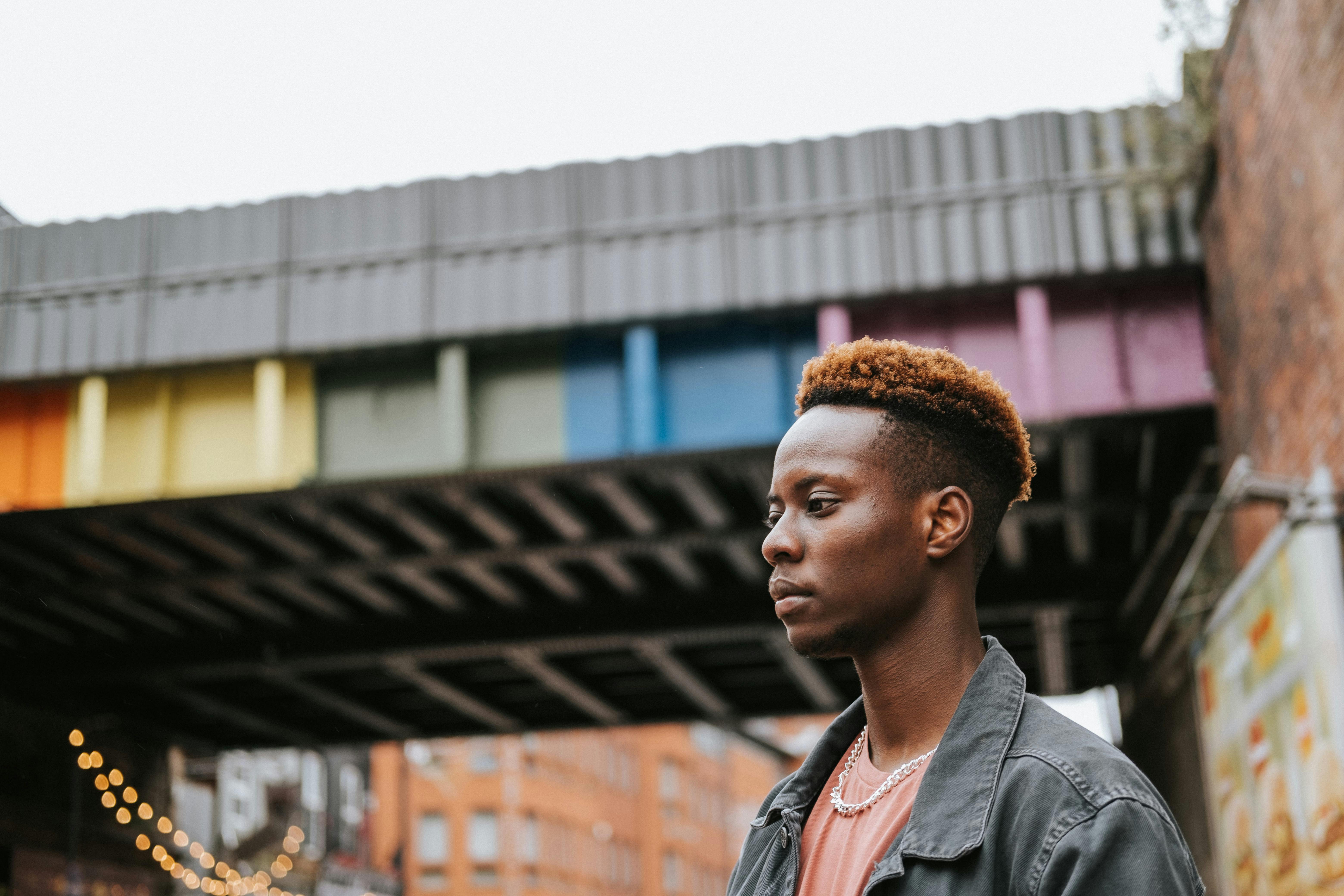 black homosexual man standing near painted structure