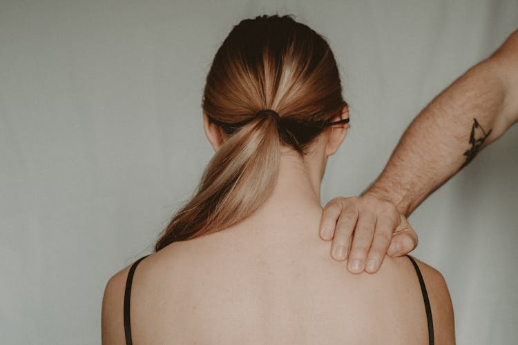 Crop Man Touching Shoulder Of Anonymous Woman