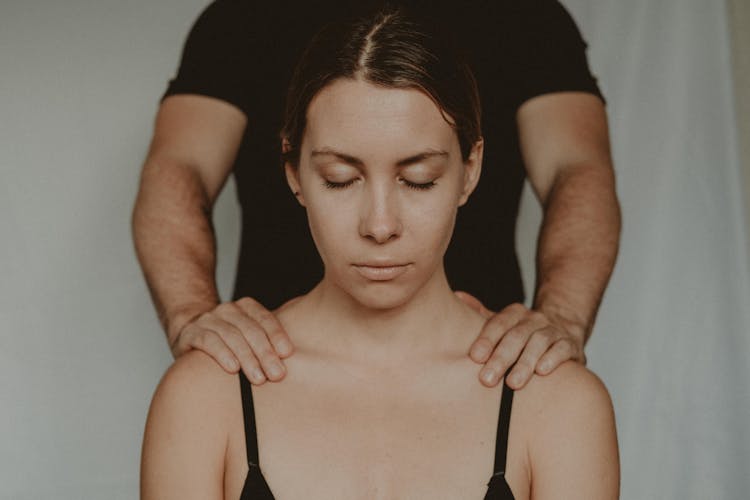 Crop Man Touching Shoulders Of Woman