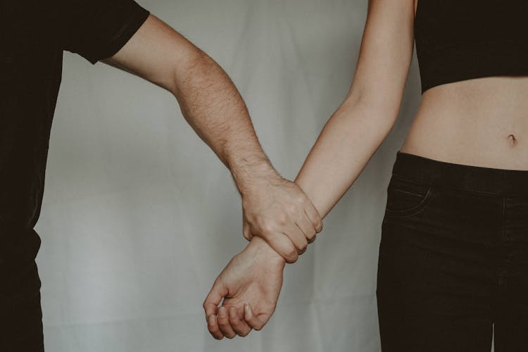 Crop Man Grasping Hand Of Woman