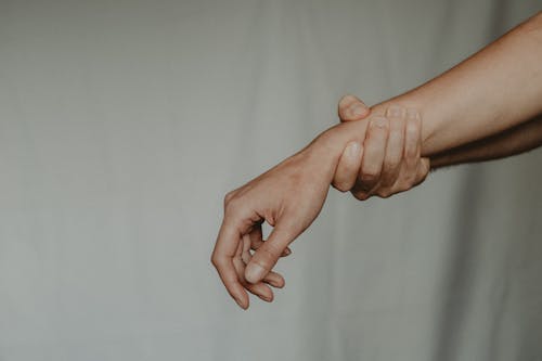 Free Unrecognizable person holding hand of partner abusively Stock Photo
