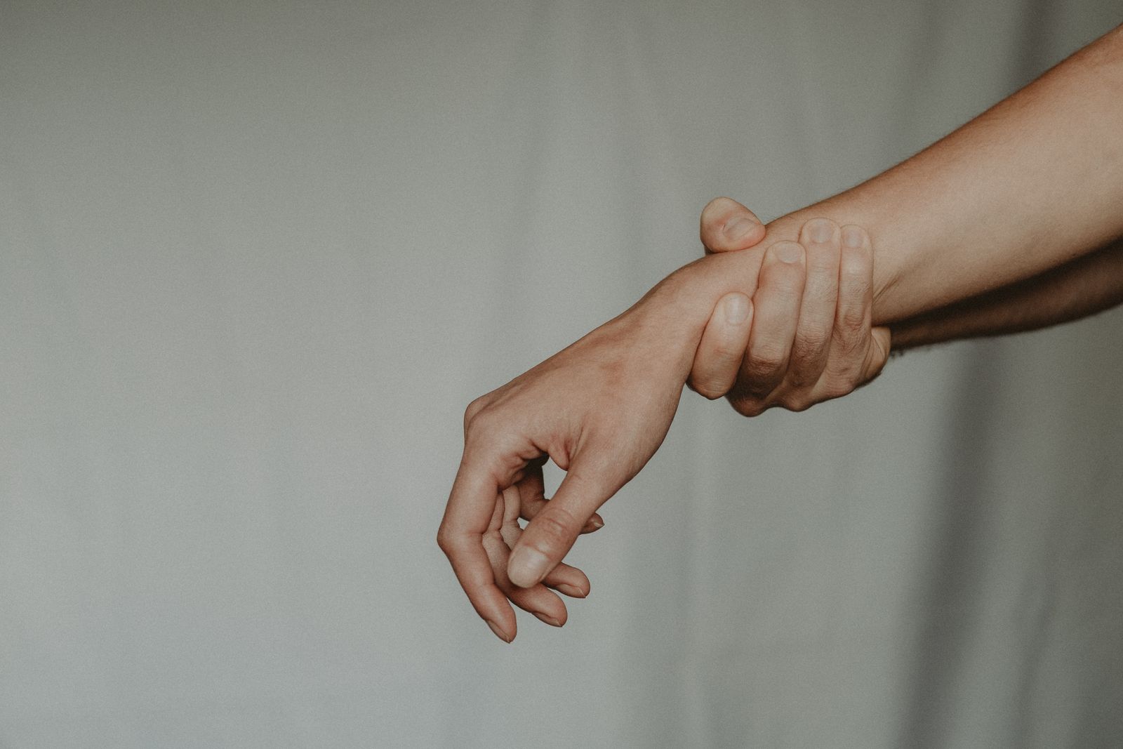 Person adjusting a hand and finger support during daily activity
