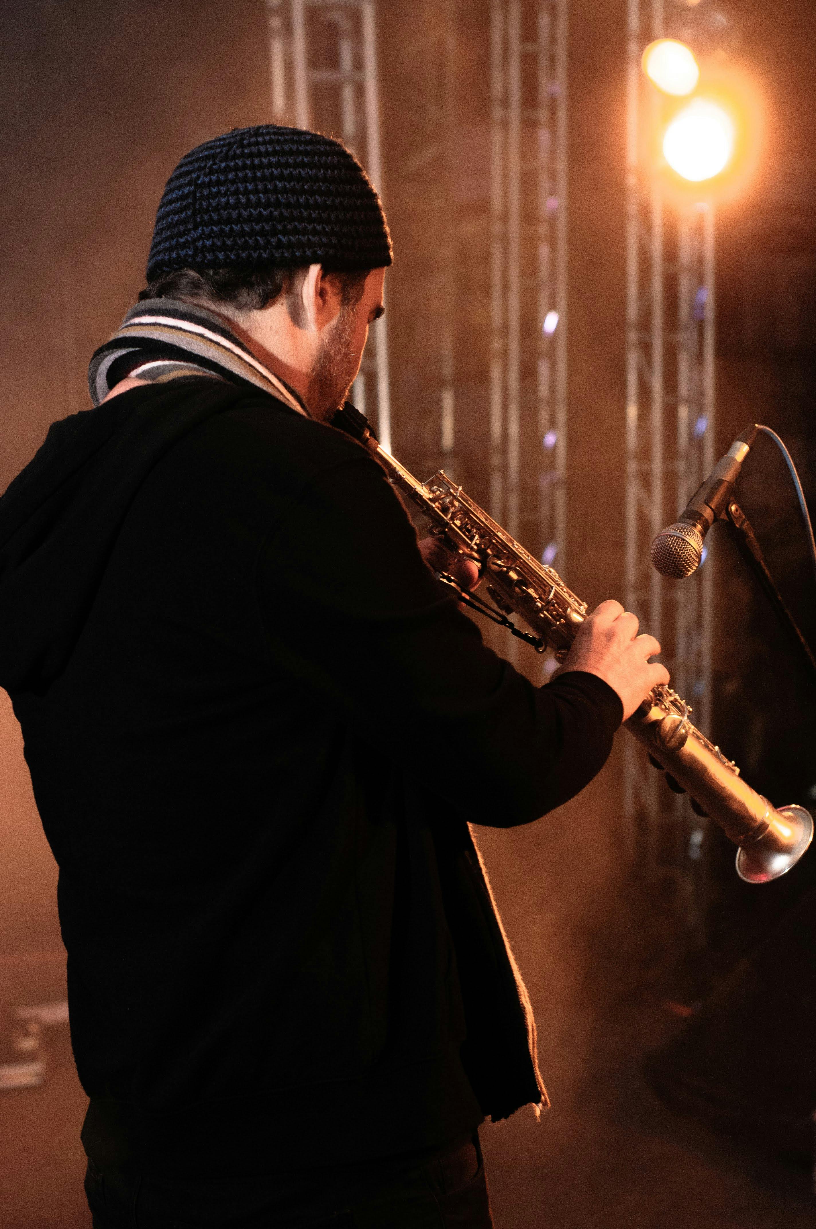 musician playing saxophone on stage at spotlight