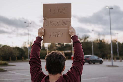 Free Man with slogan love should not hurt Stock Photo