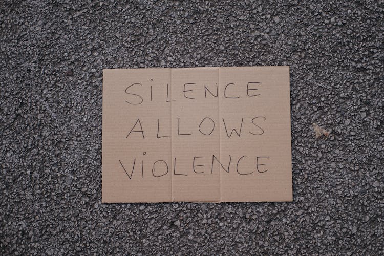 Slogan Silence Allows Violence On Asphalt Road